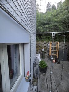 Katzennetz auf einer Terrasse als Freilauf für die Katzen / Tiere in Zürich. Schutz vor dem davonlaufen der Tiere. Eingebaute Türe in das Schutznetz. Hochwertige Materialien
